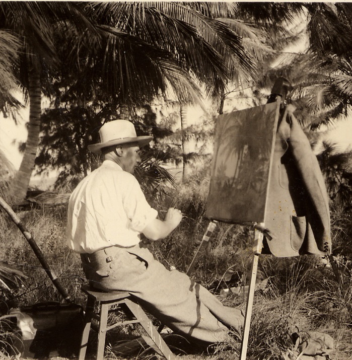 A. Paul Weber malt an einer Staffelei unter Palmen.